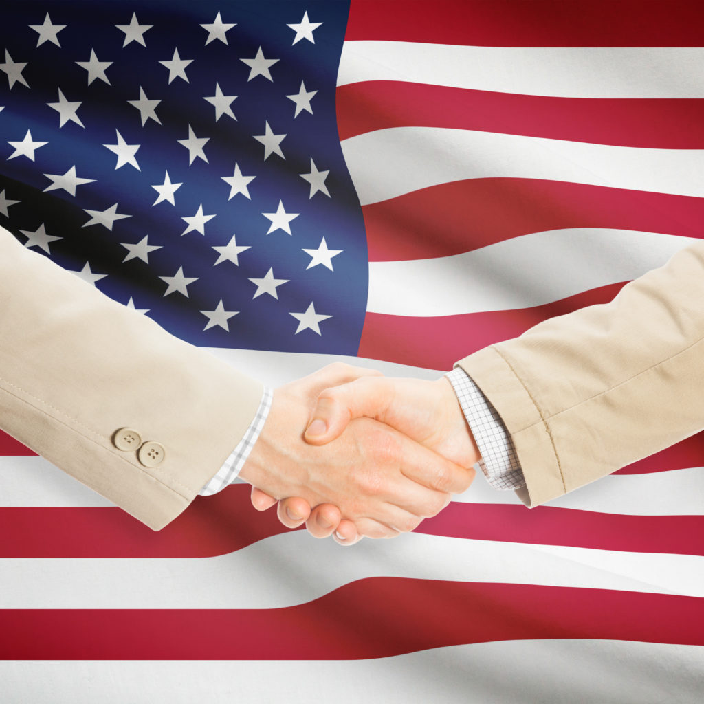 Businessmen Handshake With Flag On Background - United States - Hjaerospace